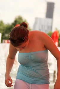 Big boobed girl in blue top with no bra playing in the water