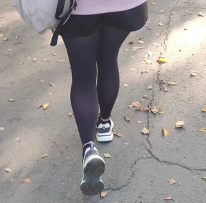 Street Photo of a College Teen's Legs in Black Pantyhose, Dressed in Shorts And Sneakers
