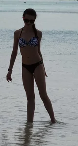 Two candid skinny teen sisters in bikinis