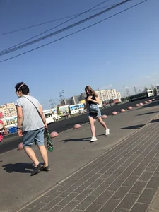 A very cute street candid girl wearing a denim fringed skirt passing by, great legs