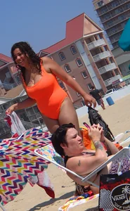 Beach girl with big boobs in an orange swimsuit