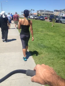 Hot brunette babe in leggings walking her dog with a nice ass and some cleavage