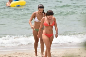 Two sexy ass girls on the beach in bikinis