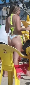 Blonde beach babe in a white and yellow thong bikini