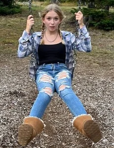 Non-candid teen in jeans on a swing