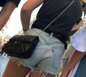 Shorts girl walking with nice legs and some cheeks showing