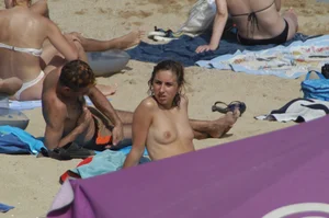 Topless girls on a beach in Barcelona