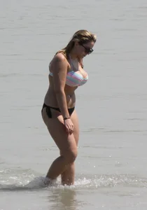 Big boobed thick blonde on the beach in a bikini