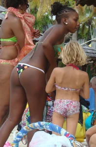 Sexy black babe in various bikinis on the beach while on vacation