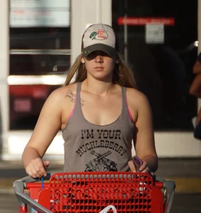 Hot blonde after shopping in short jean shorts and tank top