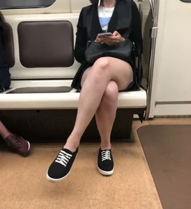 Hot Girl in a Mask Sitting With Crossed Legs in the Subway Train Candid Photos
