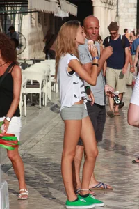 Sexy skinny blonde eating ice cream in short tight grey shorts