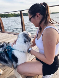 Girl in Shorts Petting a Dog
