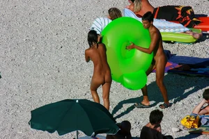 FKK Nudists playing in the water with floater