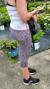 Milf booty in tight leggings shopping for plants