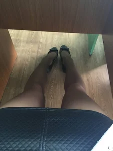 Long Skinny Legs in a Skirt And Pantyhose And Feet in Flats Under Desk Selfie