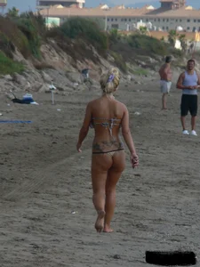 Tattooed blonde with big tits topless and in thong
