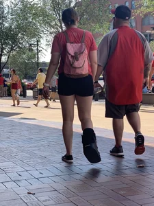 Bunch of girls in various outfits at a Cardinals baseball game