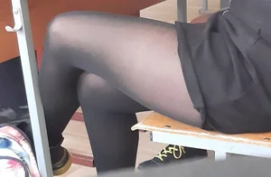 Legs of candid college teens wearing pantyhose in class