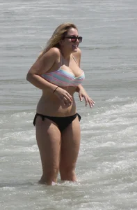 Big boobed thick blonde on the beach in a bikini
