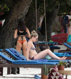 Sexy brunette friends on the beach in bikinis with great bodies