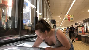 Thick girl showing cleavage while downbloused at the market