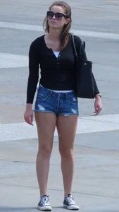 Cute girl with nice legs in short denim shorts