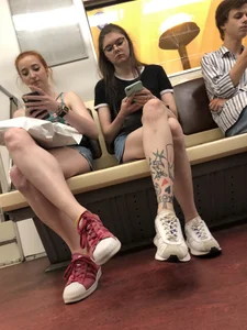 Two Girls With Hot Long Legs in Mini Shorts and Sneakers in the Subway Train Candid Photo Gallery