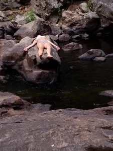 Hot Girl in a Swimsuit Lying on a Cliff