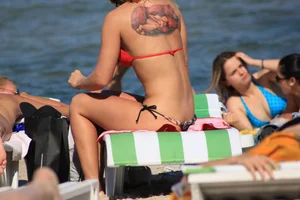 A couple sexy girls laying out on the beach