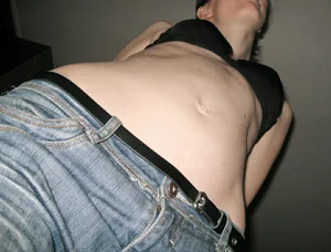 Girl in jeans and a bra low angle creepshot of her stomach