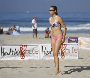 Hot girls playing beach volleyball in bikinis and shorts