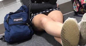 Girl in a Dress Sitting on the Floor With Crossed Legs