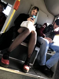 Amazing legs in black pantyhose in a public bus