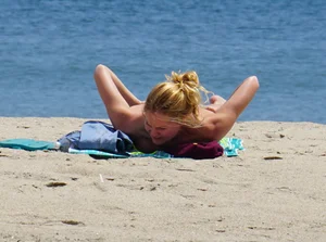 Sexy ass blonde milf on the beach in a thong with cameltoe and bending over