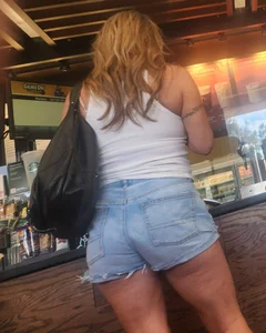 Short shorts on hot milf buying coffee