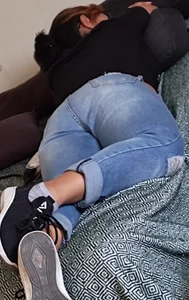 Girl in blue jeans lying in bed home creepshot