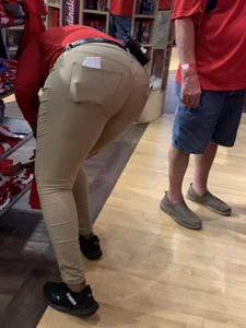 Bunch of girls in various outfits at a Cardinals baseball game