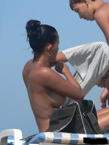 Hot ass topless beach girl with great tits lets her little brother oil up her ass in thong bikini