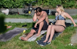 Thick blonde laying out in the sun in a bikini with her boyfriend