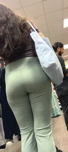 Hot brunette milf in green yoga flare at GameStop