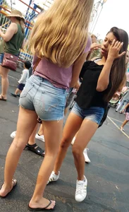 Bunch of skinny teens in shorts at the fun fair