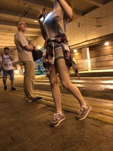Cute Teen in Shorts on the Tram Stop