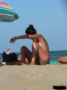 Bunch of sexy babes on the beach topless and in thong bikinis