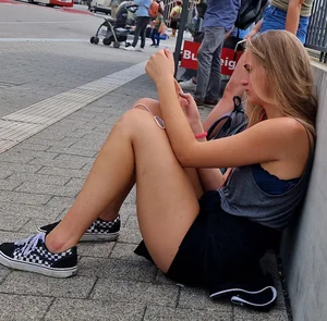 Candid Girl in Shorts Sitting on the Pavement on the Street With Her Phone, Juicy Legs Creepshots