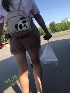 Young Girl in Sandals and Shorts in a Public Bus