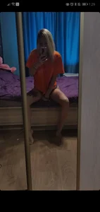 Tattooed Blonde Sitting in Bed Mirror Selfie