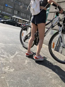 Bike girl's hot slim legs and booty in shorts