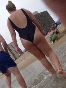 Thick blonde on the beach with a big booty in a blue swimsuit