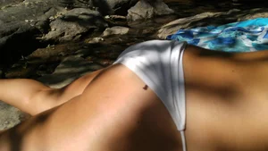 Sexy bikini ass laying out on the rocks up close